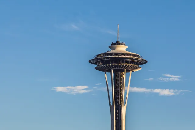 The upper Space Needle against a blue sky in Seattle.