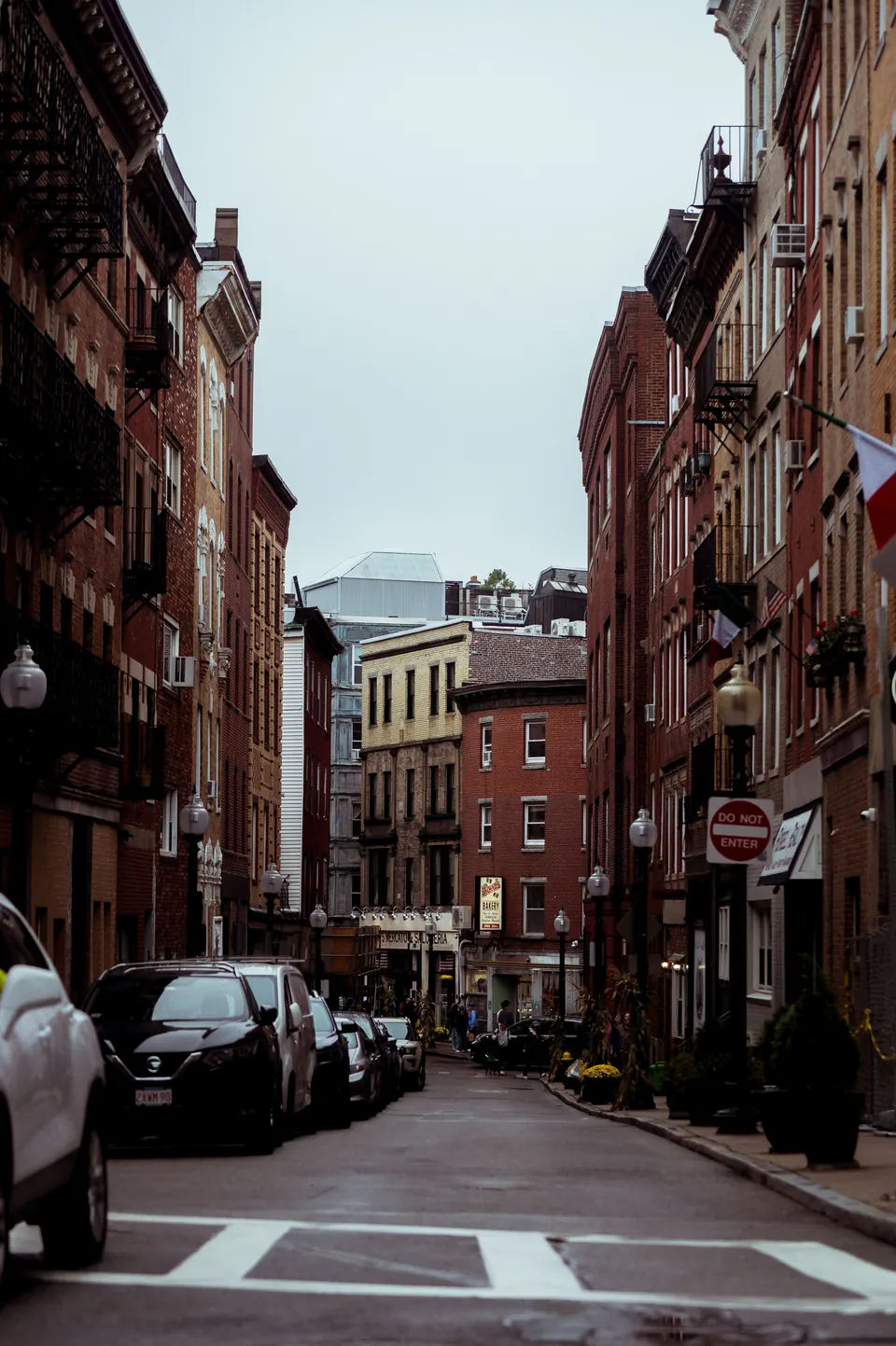 Brick residential buildings along a narrow street in Boston’s North End