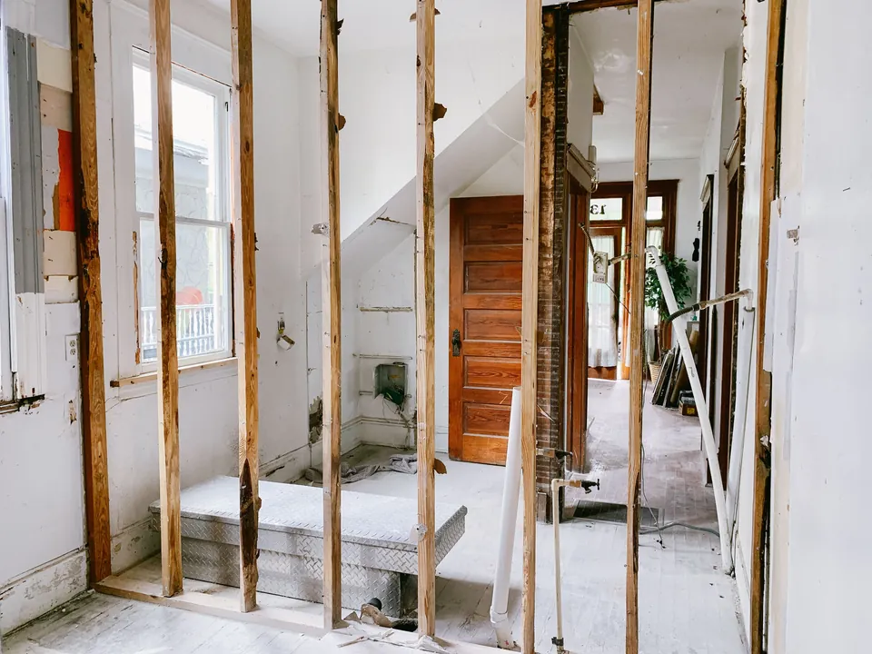 An unfinished home interior with exposed wooden framing